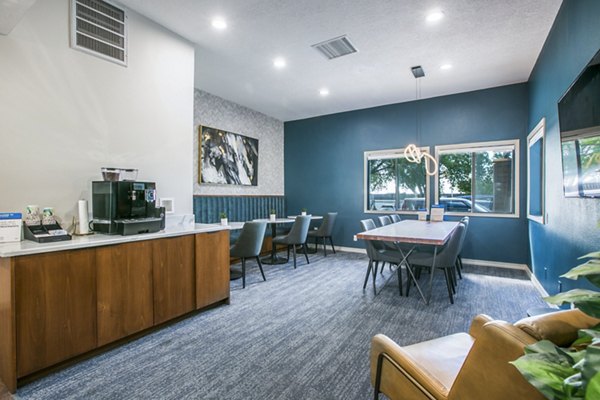 Elegant lobby with modern design at AYA ABQ Apartments featuring comfortable seating and stylish lighting fixtures, ideal for relaxation and socializing
