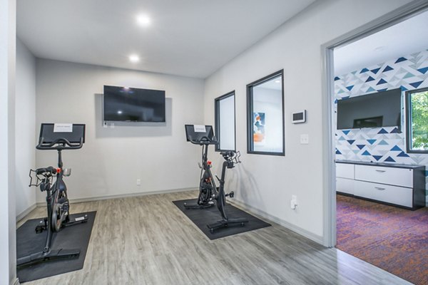 Spin studio with modern bikes and mirrored walls at AYA ABQ Apartments for fitness enthusiasts