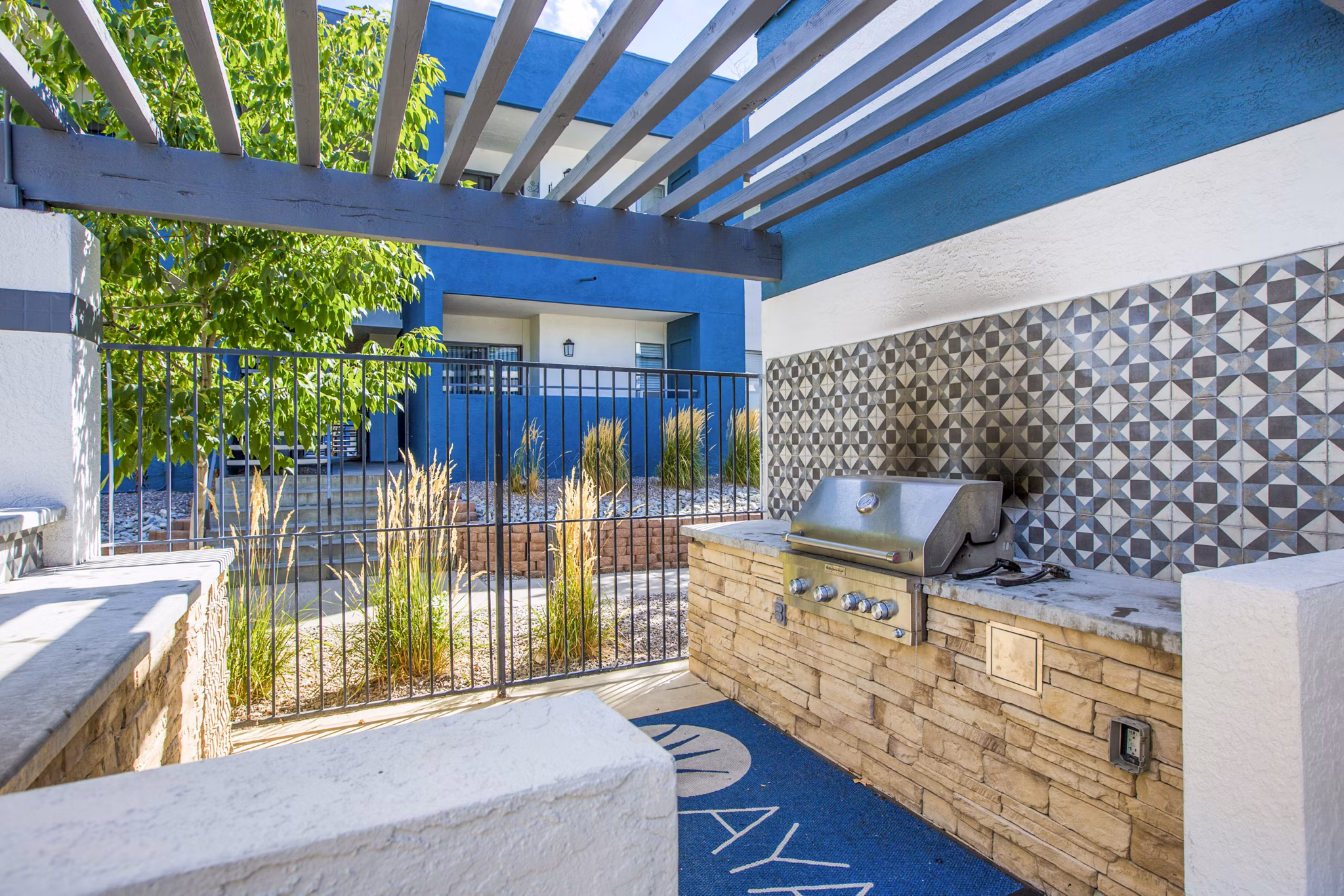 Outdoor leisure area with communal grills and seating at AYA ABQ Apartments, offering a perfect spot for social gatherings in Albuquerque, NM