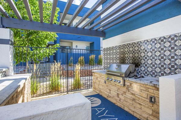 Outdoor leisure area with communal grills and seating at AYA ABQ Apartments, offering a perfect spot for social gatherings in Albuquerque, NM