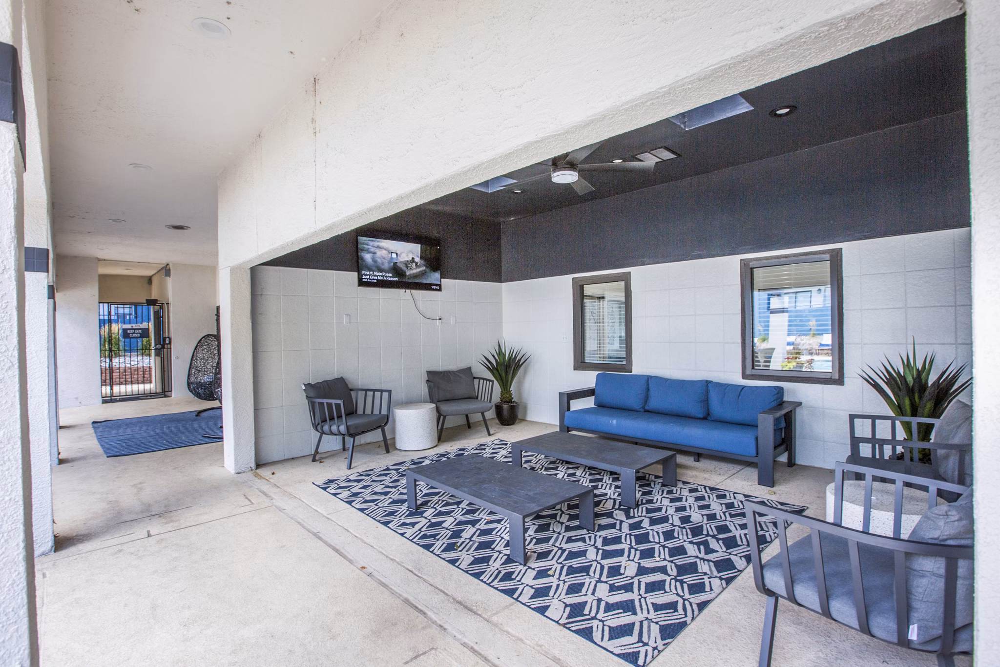 Outdoor grill patio area with modern seating at AYA ABQ Apartments, perfect for gatherings and relaxation in a luxurious setting