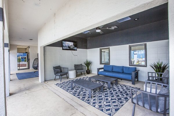 Outdoor grill patio area with modern seating at AYA ABQ Apartments, perfect for gatherings and relaxation in a luxurious setting