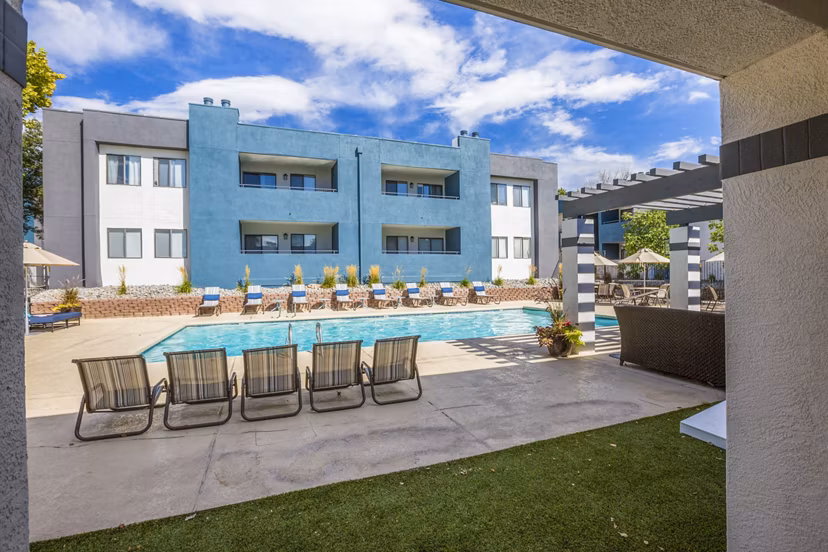 Relaxing pool area with loungers at AYA ABQ Apartments