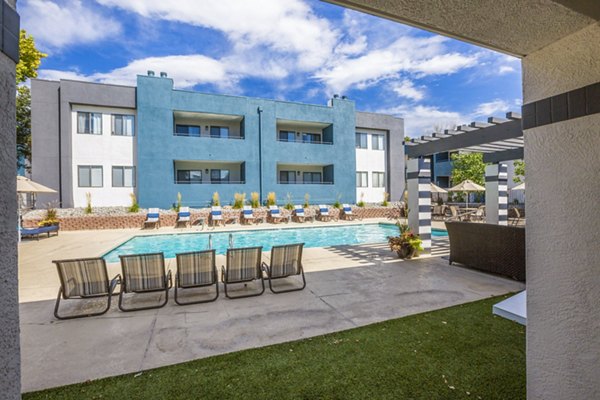 Relaxing pool area with loungers at AYA ABQ Apartments