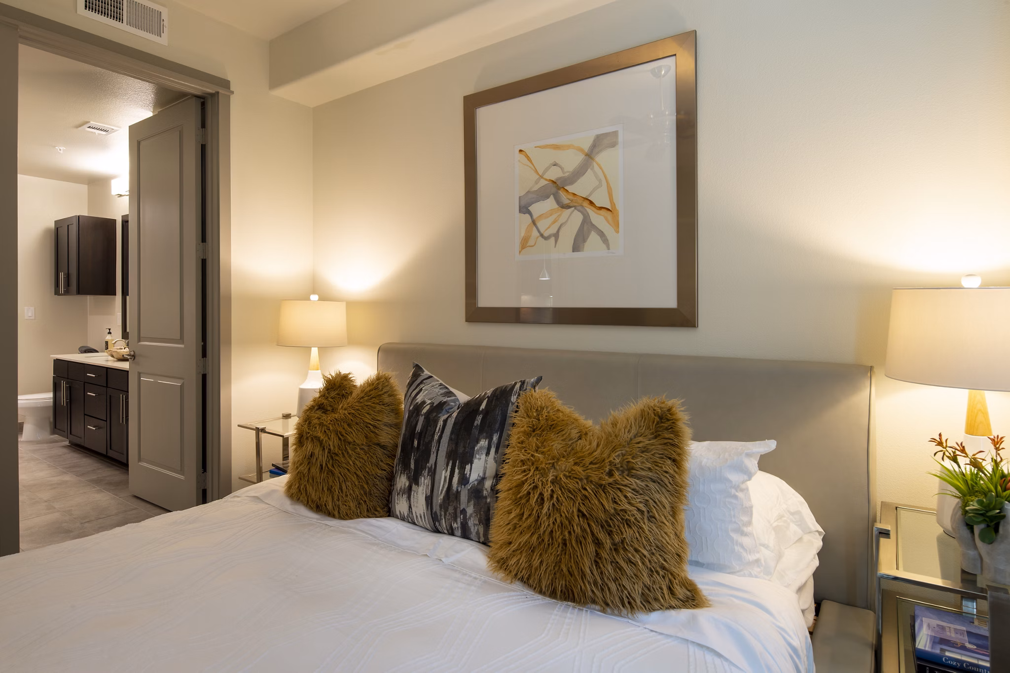 Cozy bedroom with modern design elements at 1414 Texas Downtown Apartments, offering luxury living in an upscale urban setting