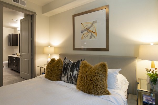Cozy bedroom with modern design elements at 1414 Texas Downtown Apartments, offering luxury living in an upscale urban setting