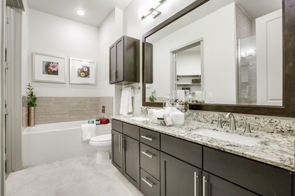 Bathroom with modern fixtures and sleek design at 1414 Texas Downtown Apartments in vibrant central location