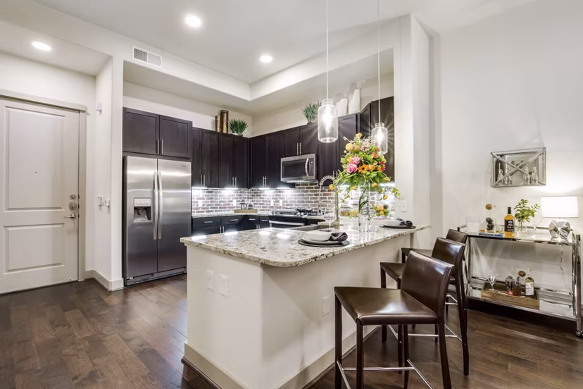 Modern kitchen with stainless steel appliances at 1414 Texas Downtown Apartments Perfect blend of style and functionality in luxury living