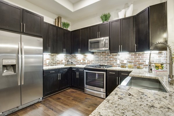 Contemporary kitchen with sleek stainless steel appliances at 1414 Texas Downtown Apartments