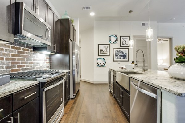 Modern kitchen with sleek countertops and stainless-steel appliances in 1414 Texas Downtown Apartments
