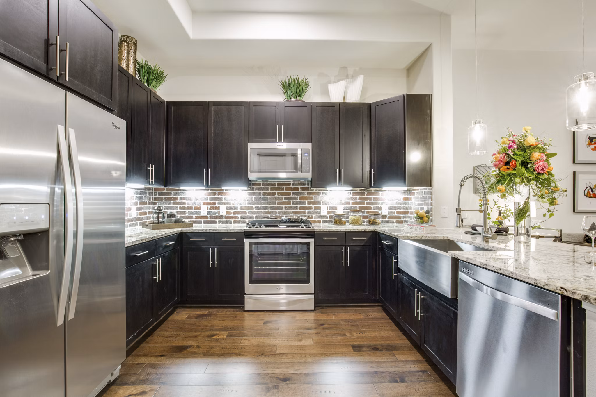 Modern kitchen with stainless steel appliances and granite countertops at 1414 Texas Downtown Apartments, luxury living in central location