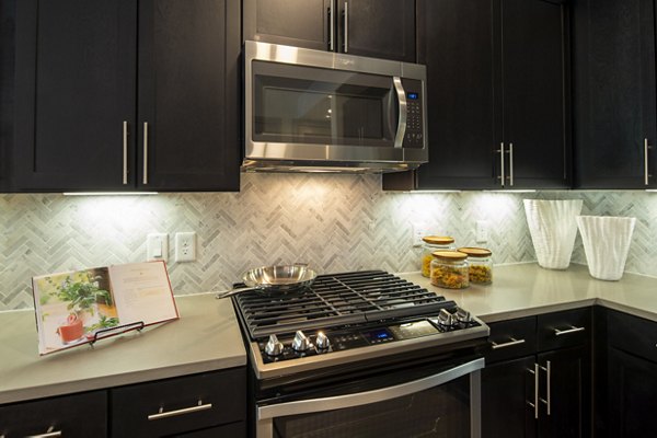 Modern kitchen with sleek countertops and stainless steel appliances at 1414 Texas Downtown Apartments