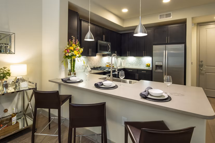 Modern kitchen with stainless steel appliances in 1414 Texas Downtown Apartments, offering luxury living spaces in an urban setting