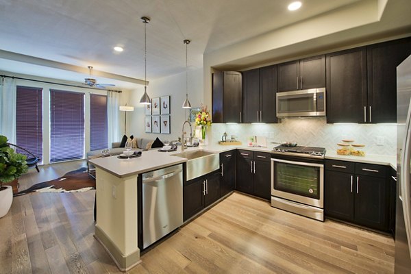 Modern kitchen with sleek cabinets and stainless steel appliances at 1414 Texas Downtown Apartments