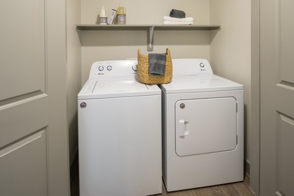 Laundry room featuring modern appliances at 1414 Texas Downtown Apartments