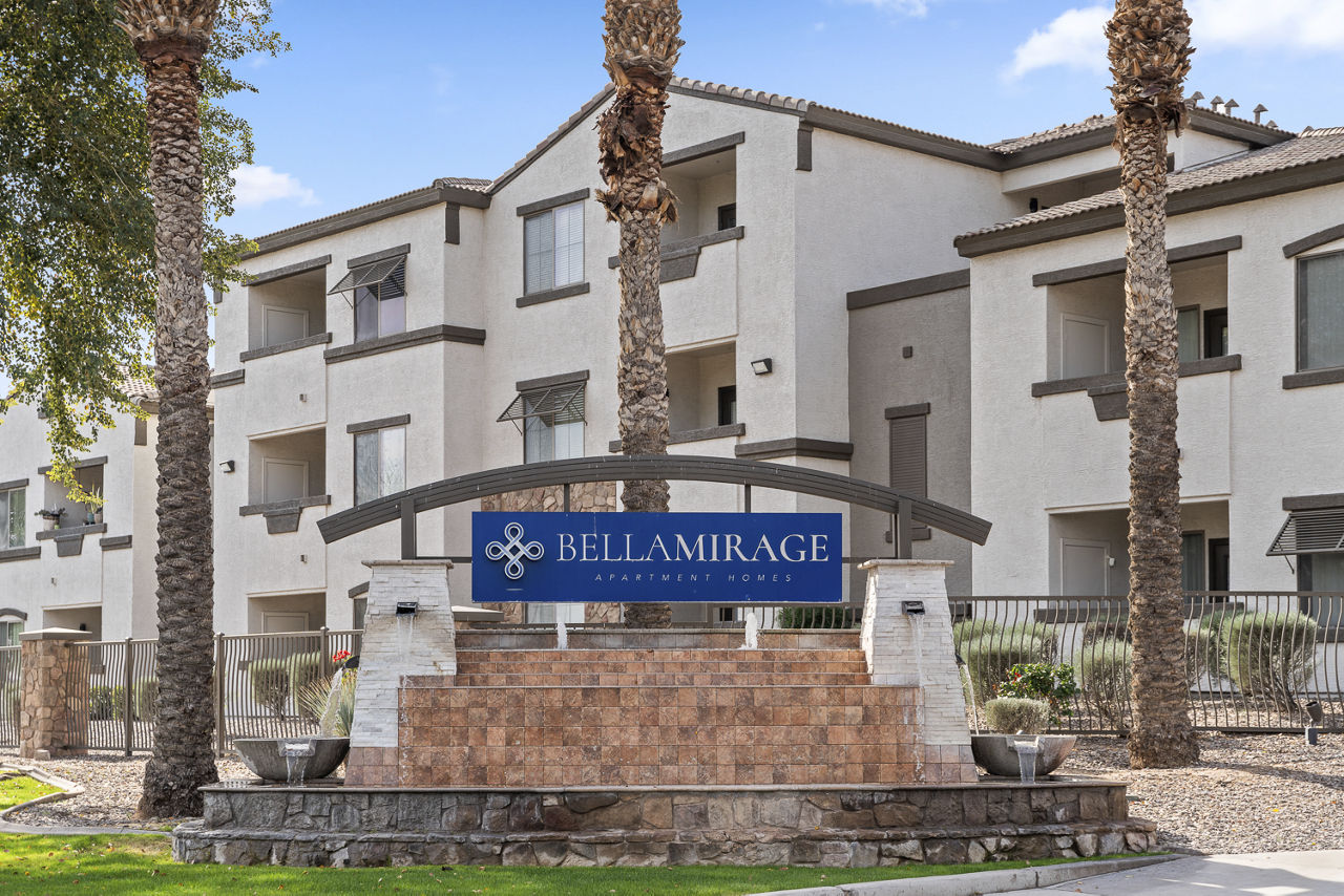 Bella Mirage entrance sign in front of apartment buildings.