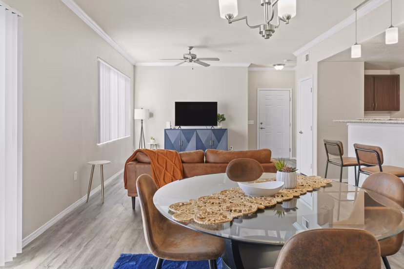 Dining room featuring elegant decor and natural lighting at Bella Mirage Apartments, a Greystar luxury apartment community