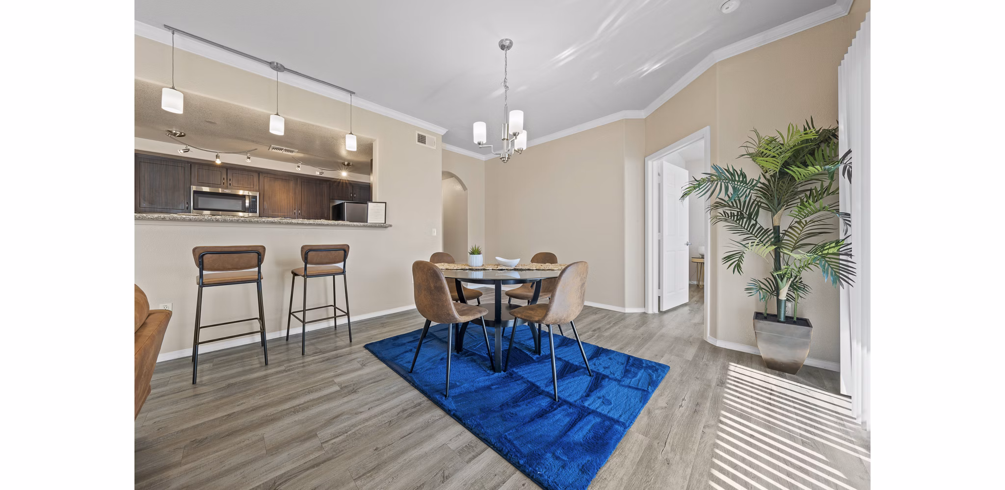 Dining room featuring elegant decor and natural lighting at Bella Mirage Apartments, a Greystar luxury apartment community