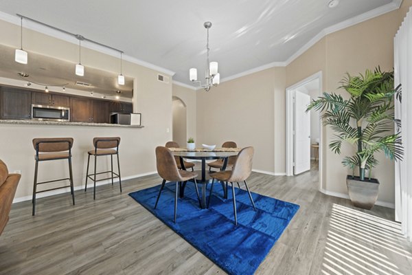 Dining room featuring elegant decor and natural lighting at Bella Mirage Apartments, a Greystar luxury apartment community