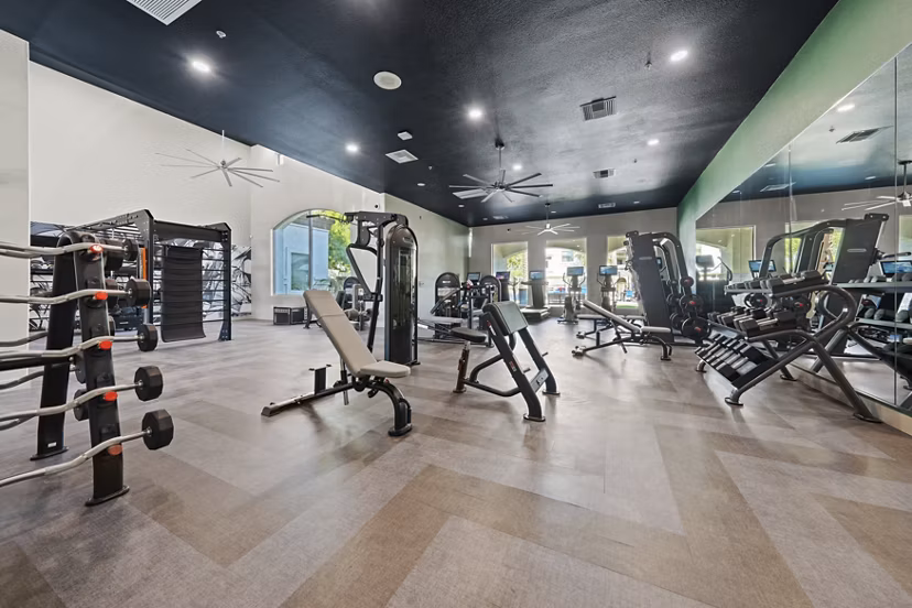 State-of-the-art fitness center with modern equipment at Bella Mirage Apartments