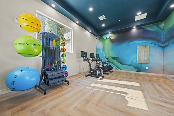 Fitness center with modern equipment at Bella Mirage Apartments