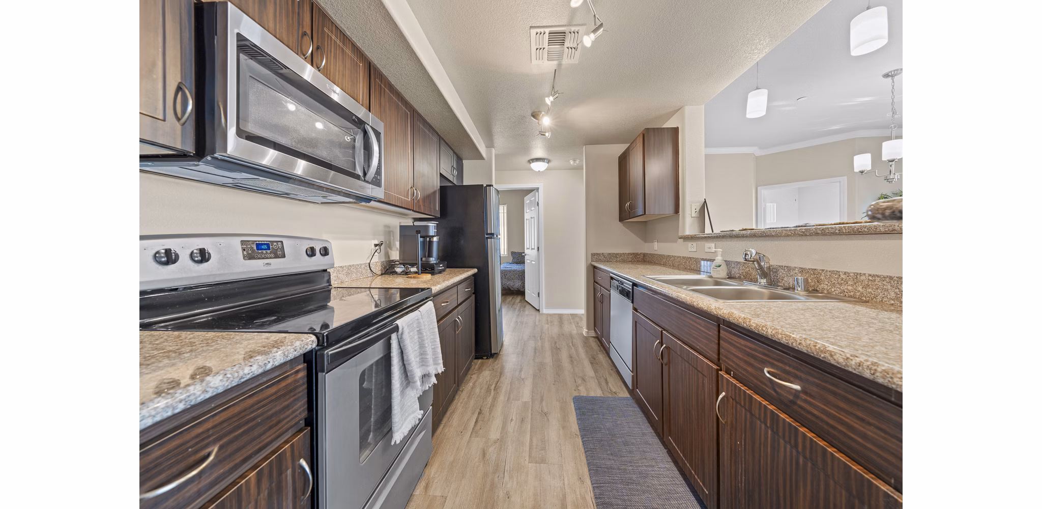 Modern kitchen with sleek countertops and stainless steel appliances at Bella Mirage Apartments