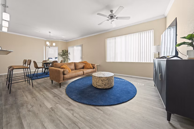 Spacious living room with modern decor and natural light in Bella Mirage Apartments