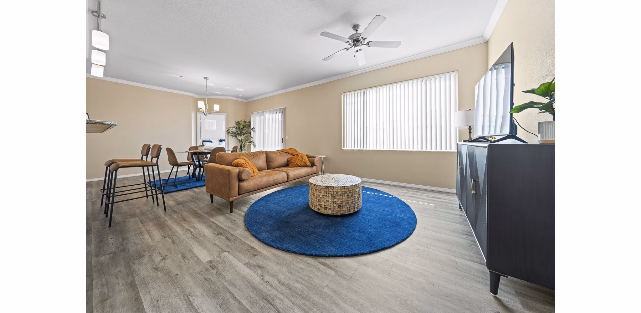 Spacious living room with modern decor and natural light in Bella Mirage Apartments