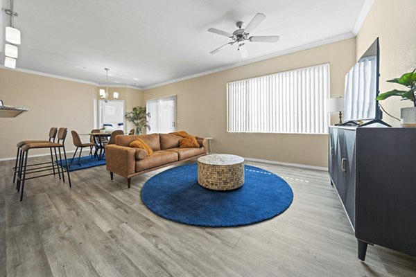 Spacious living room with modern decor and natural light in Bella Mirage Apartments