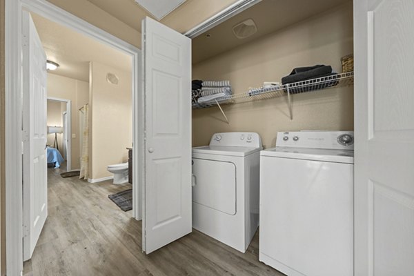 Laundry room with modern appliances at Bella Mirage Apartments, offering a convenient and clean space for residents' laundry needs