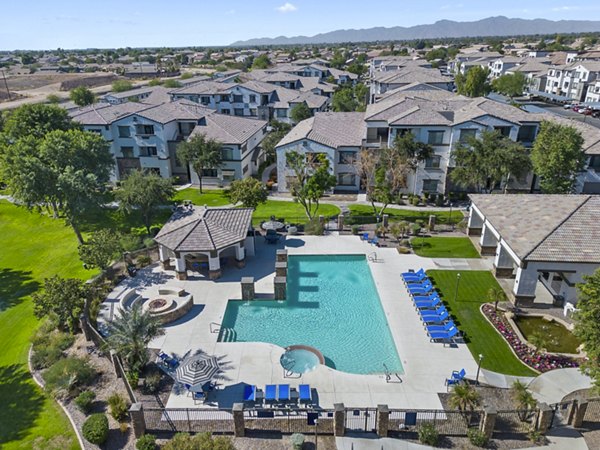 Outdoor pool with lounge chairs at Bella Mirage Apartments, a luxury Greystar property in Scottsdale, offering a resort-style living experience