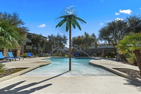 Infinity-edge pool at Bella Mirage Apartments featuring luxurious poolside cabanas for ultimate relaxation