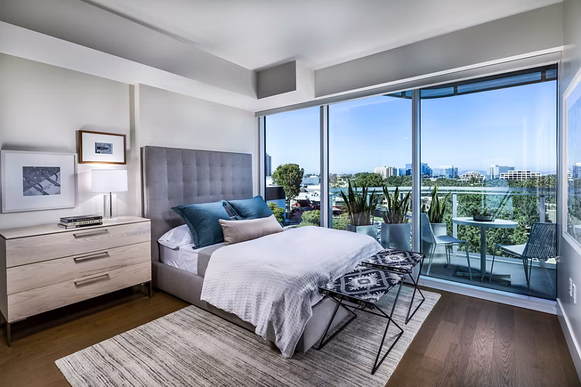 Bedroom with modern furnishings including a plush bed and stylish decor at Palisade at Westfield UTC Apartments