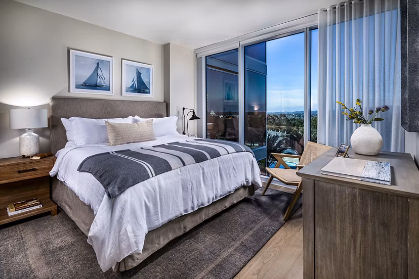 Luxurious bedroom featuring a king-sized bed and modern decor in Palisade at Westfield UTC Apartments