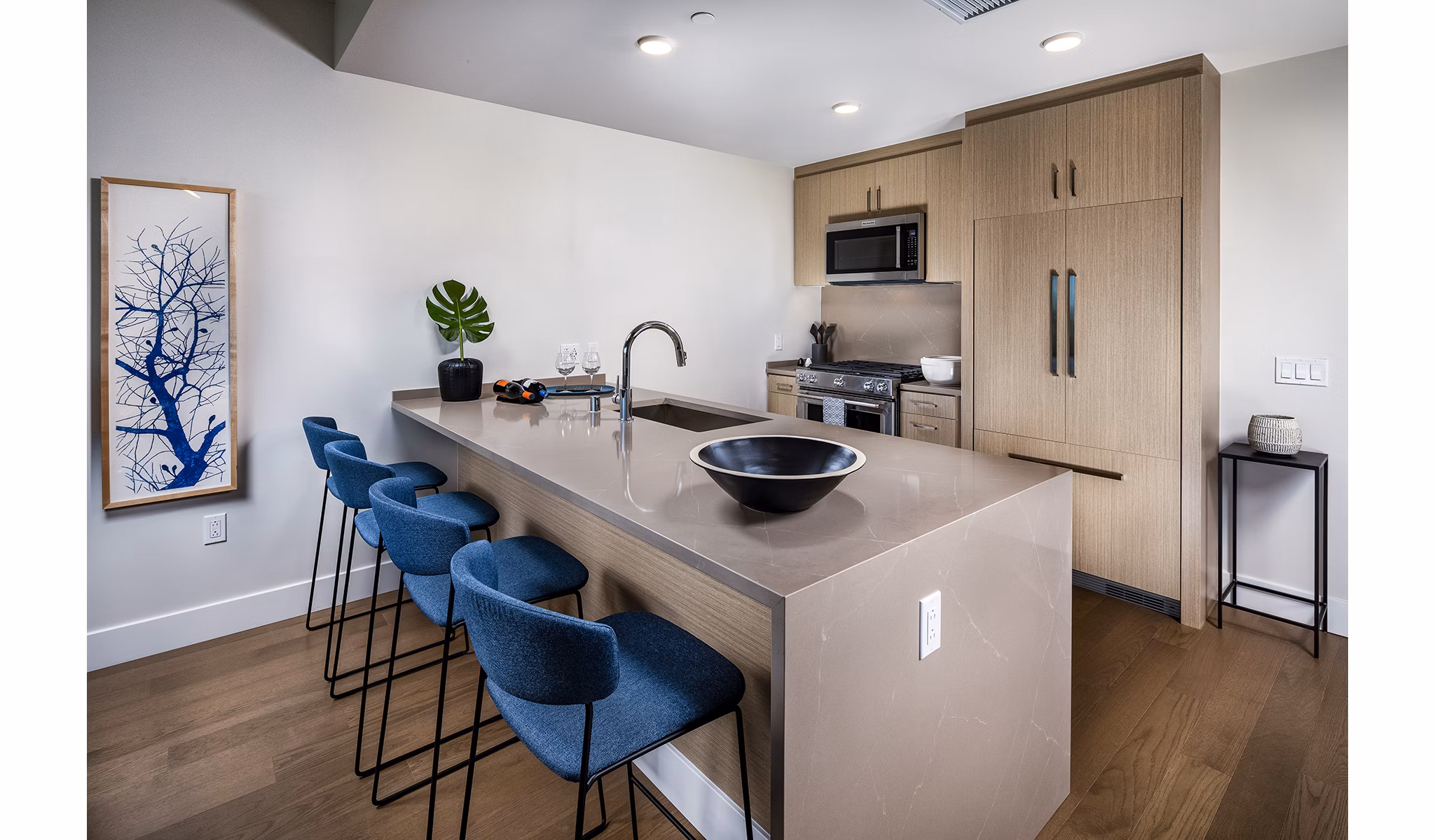 Modern kitchen with stainless steel appliances and white cabinetry in Palisade at Westfield UTC Apartments