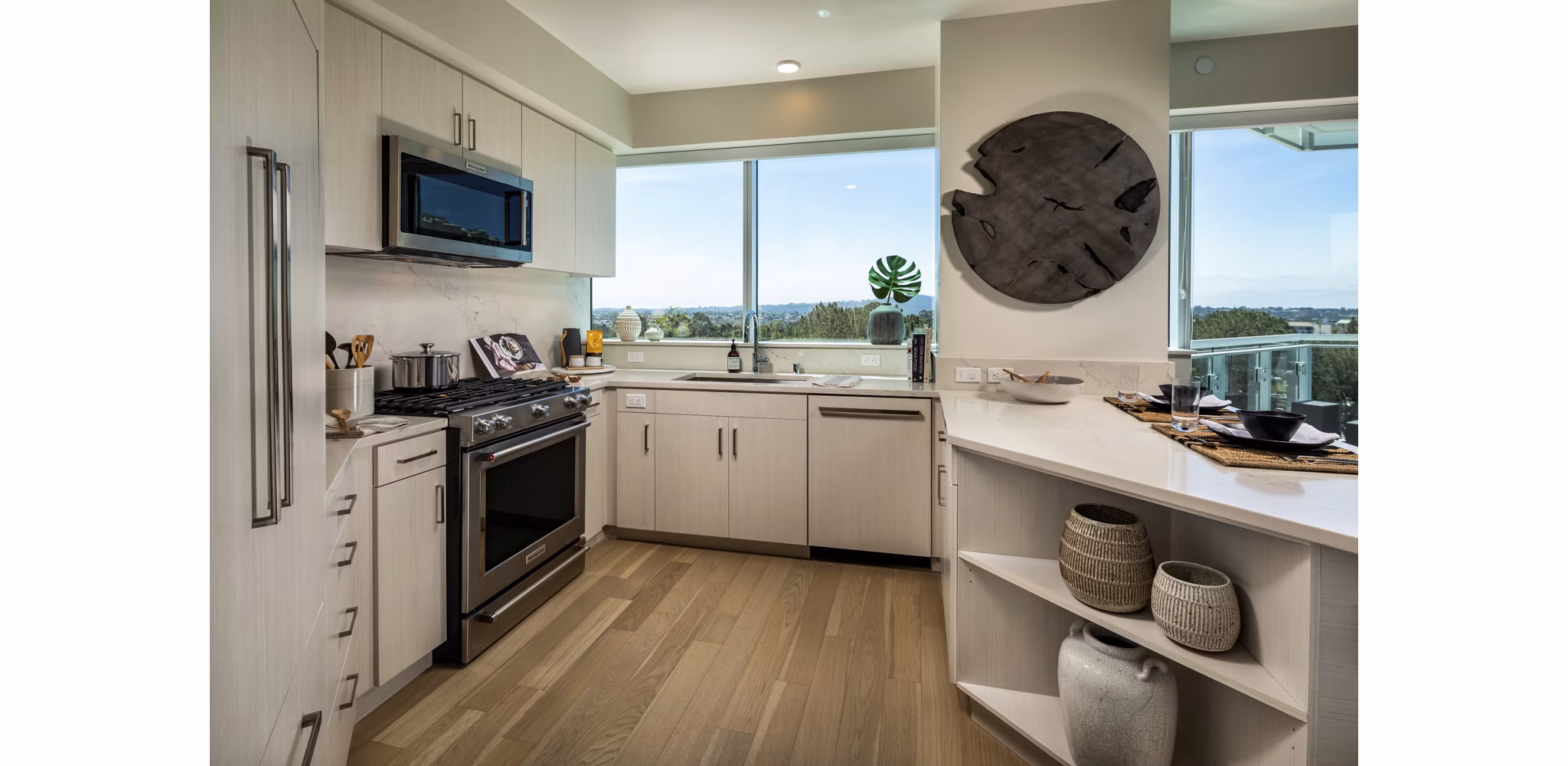 Modern kitchen with stainless steel appliances at Palisade at Westfield UTC Apartments