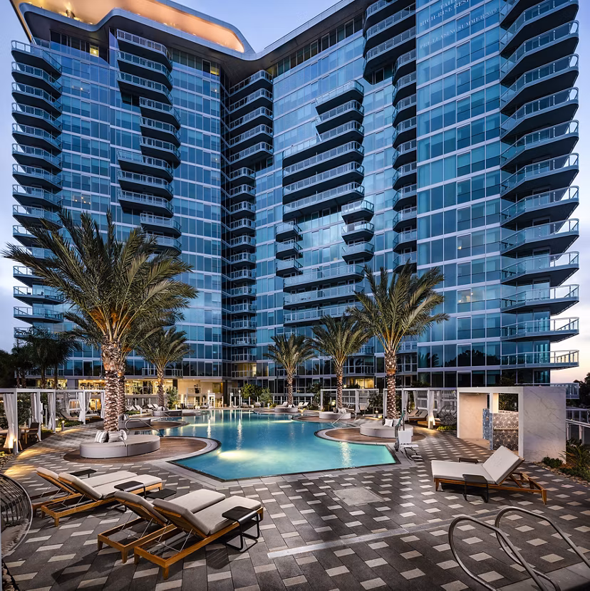 Resort-style pool with lounge chairs at Palisade at Westfield UTC Apartments, offering luxurious living in a vibrant community setting