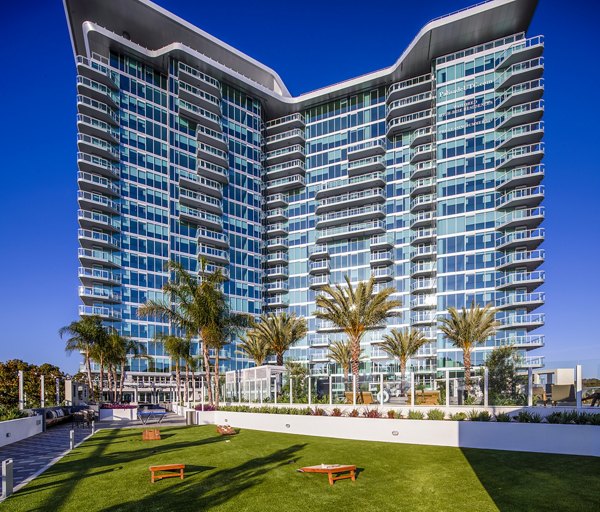 Outdoor recreation area with corn hole and sport court at Palisade at Westfield UTC Apartments