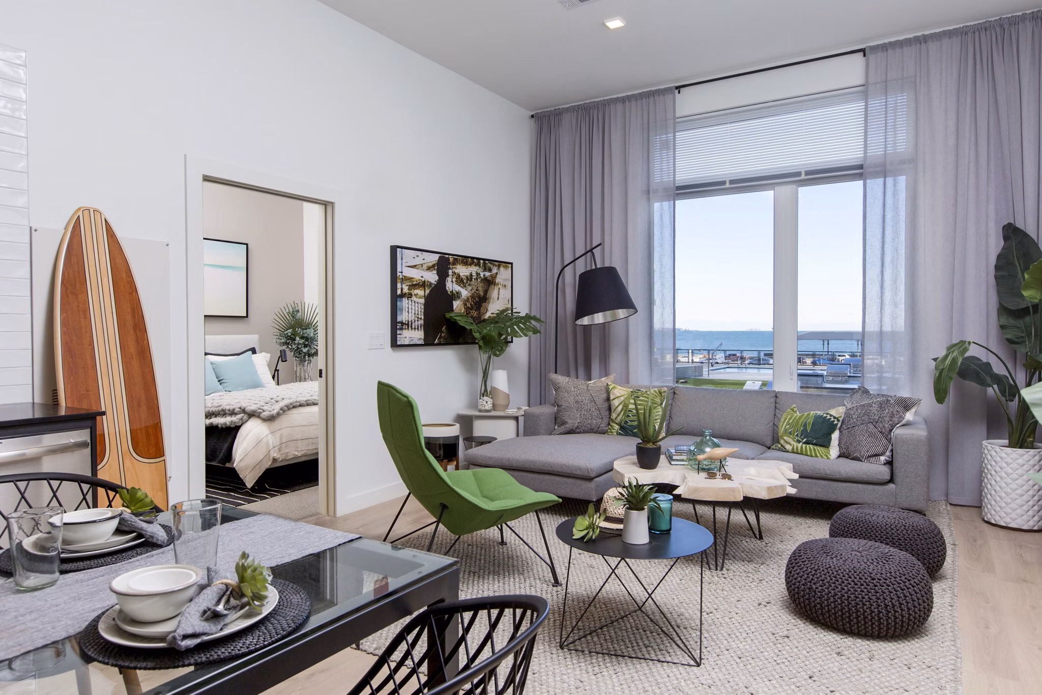 Spacious living room featuring modern decor and large windows in 500 Ocean Ave Apartments