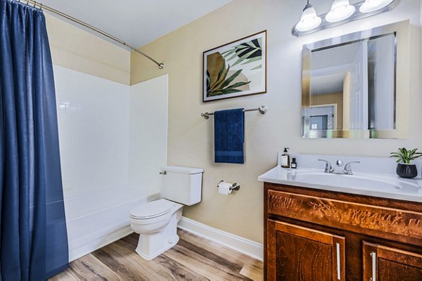 Bathroom with marble countertops and large mirrors at Poplar Glen Apartments