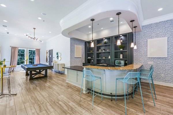 Clubhouse game room featuring arcade games and pool table at Poplar Glen luxury apartments
