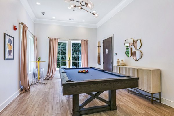 Clubhouse game room with billiards and lounge seating at Poplar Glen luxury apartments