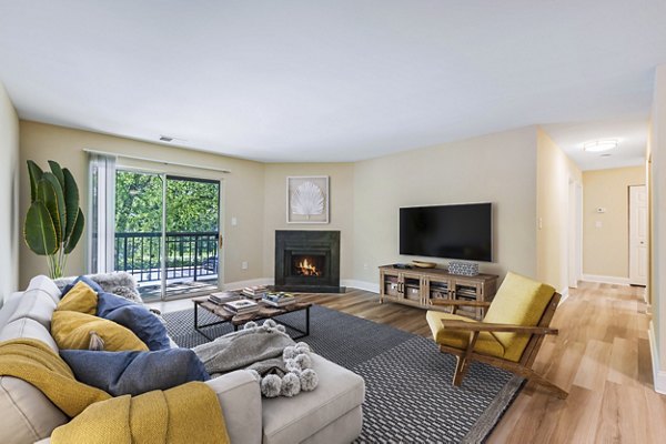 Spacious living room with modern decor and large windows at Poplar Glen Apartments, offering a luxurious lifestyle in a serene setting