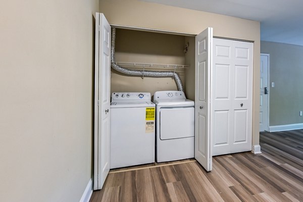 Laundry room featuring modern washers and dryers at Poplar Glen Apartments
