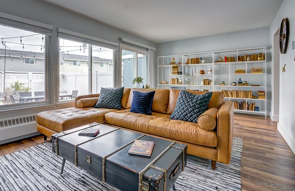 Spacious living room with modern decor at Admirals Cove Apartments, a luxury community by Greystar featuring premium amenities