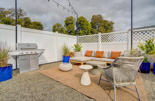 Admirals Cove Apartments: Tranquil patio space with comfortable seating and greenery, ideal for relaxation and socializing