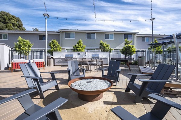 Cozy outdoor fire pit area at Admirals Cove Apartments, ideal for relaxing and social gatherings in a luxurious community setting