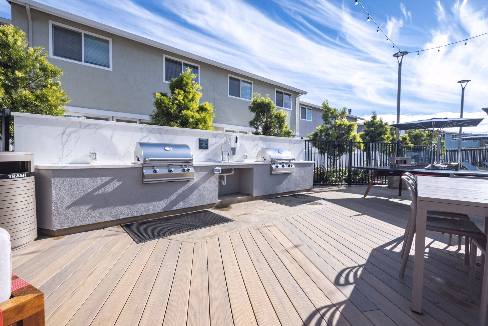 Grill area with modern seating at Admirals Cove Apartments' luxury community patio