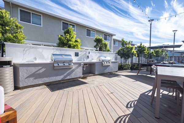 Grill area with modern seating at Admirals Cove Apartments' luxury community patio