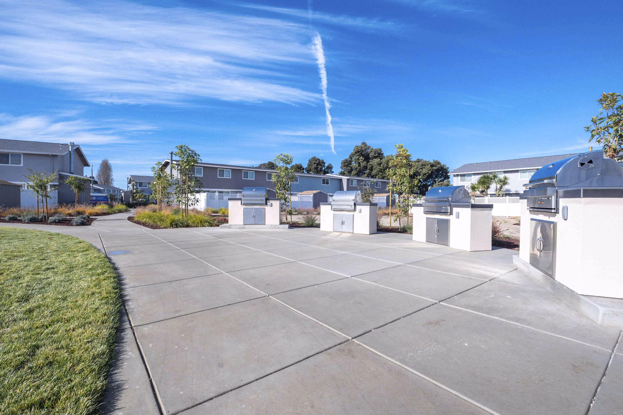 Outdoor grill area with modern seating at Admirals Cove Apartments, promoting community gatherings and leisure activities
